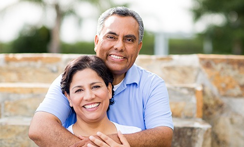 Smiling older man and woman outdoors