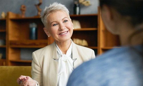 a person practicing talking with dentures