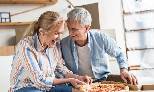 a couple eating a pizza