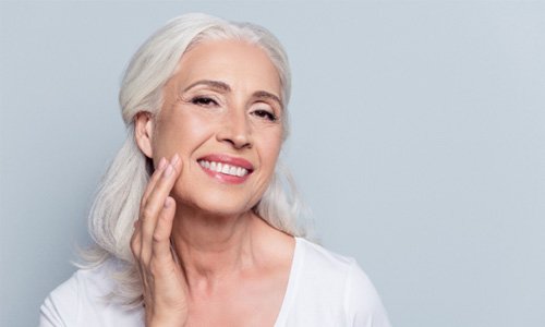 : a closeup of a patient with dentures smiling