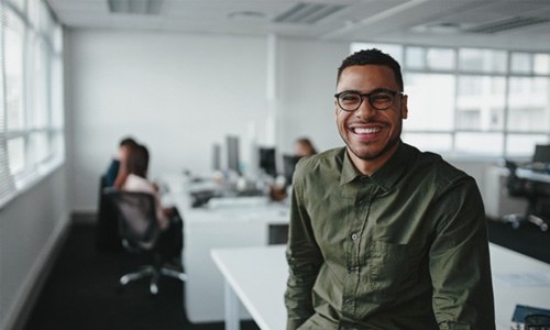 a person smiling in an office setting