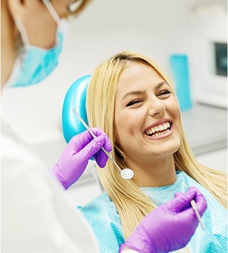 Woman in dental chair laughing