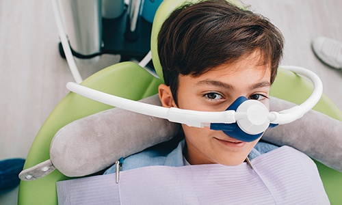 Child relaxing with nitrous oxide mask during a dental visit in Big Pine Key