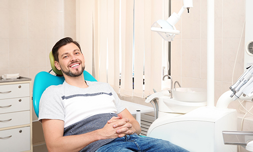 Smiling man waiting in a dental chair