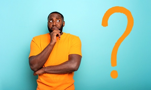Man holding his chin in uncertainty next to question mark