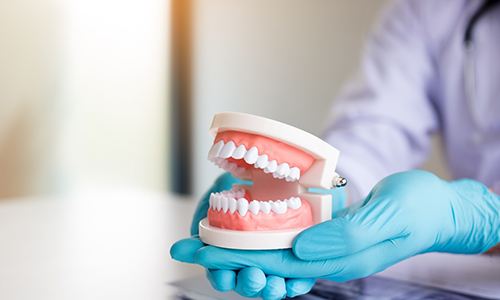 A technician making dentures for a patient