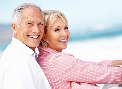 Older man and woman smiling together outdoors