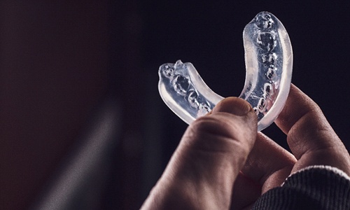 person holding mouthguard