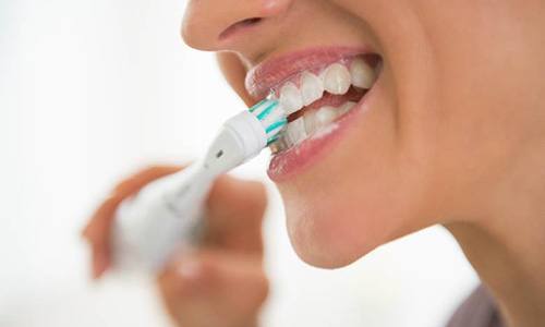 Woman brushing dental implants in Big Pine Key