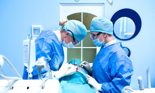 A dentist and her team perform dental implant surgery on a patient in Big Pine Key