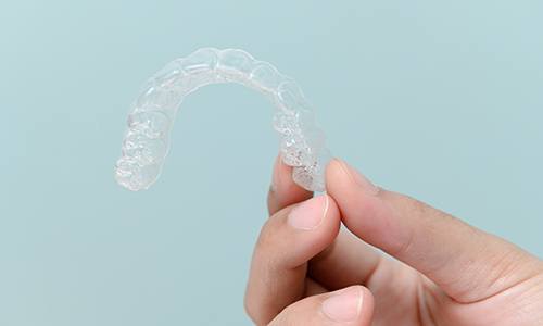 Patient holding clear aligner