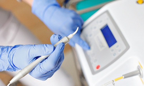 Dentist holding dental laser 