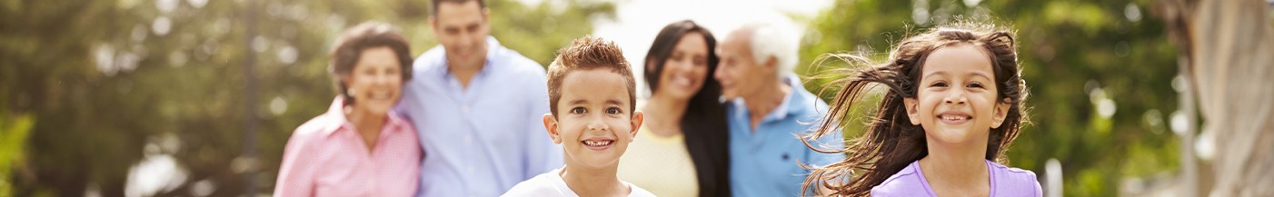 Family of six smiling outdoors after seeing dentist near Marathon