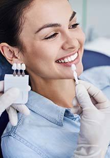 Woman trying on dental veneers from cosmetic dentist near Marathon