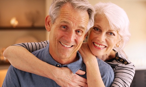 Older couple smiling with Lumineers