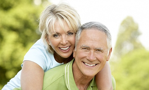 Smiling older man and woman outdoors