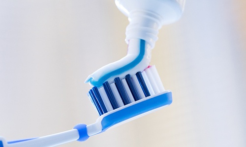 Closeup of toothbrush and toothpaste for preventing dental emergencies in Big Pine Key