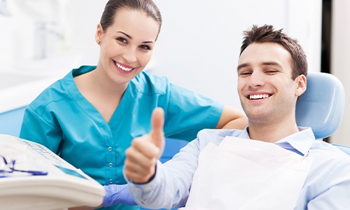 Smiling dental team member and patient