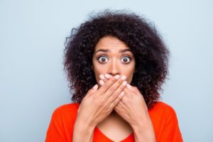 woman covering her mouth after losing porcelain veneers in Big Pine Key 