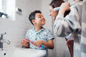 parent checking to see if their child brushed their teeth properly