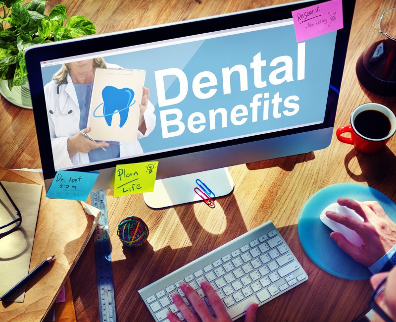 Patient researching dental insurance benefits on laptop