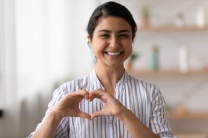 Making heart shape, thinking about connection between gum disease and heart disease