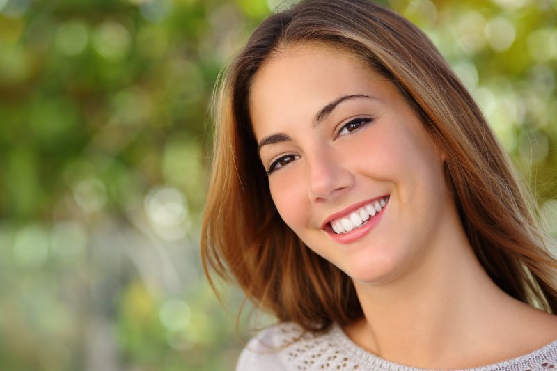 a young woman smiling after seeing a cosmetic dentist in Big Pine Key