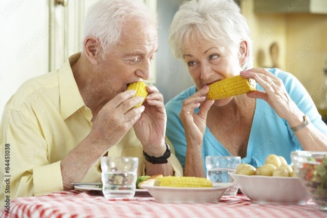 Elderly couple eating corn, one of the summer foods