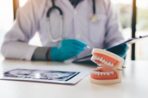 A model set of dentures resting on a table at the dentist’s office.