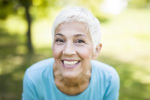 senior woman grinning outdoors