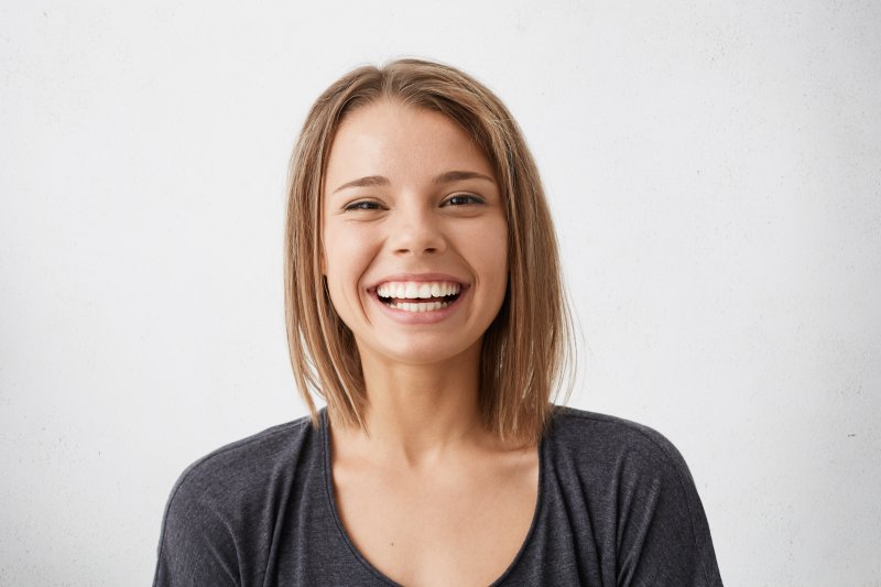 person with nice teeth thanks to dental implants smiling