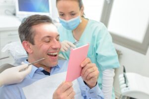 Man smiling after getting an all-ceramic crown